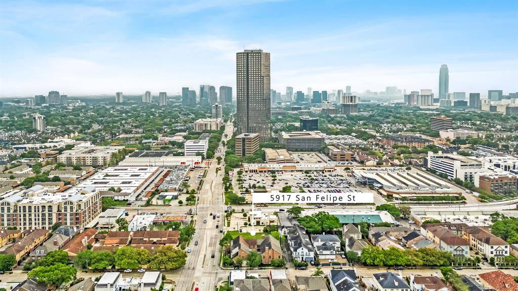 This aerial photo showcases an urban area with a mix of residential and commercial buildings. Prominent high-rises and a dense cityscape are visible, highlighting the property's central location. The area appears vibrant and well-connected, ideal for those seeking convenience and city amenities.