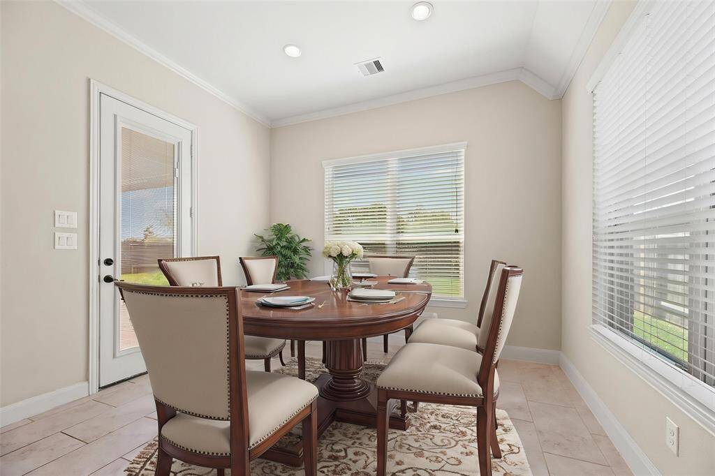 The breakfast area, conveniently located next to the kitchen and living room, offers plenty of space for a large table—perfect for family meals and gatherings! - virtually staged
