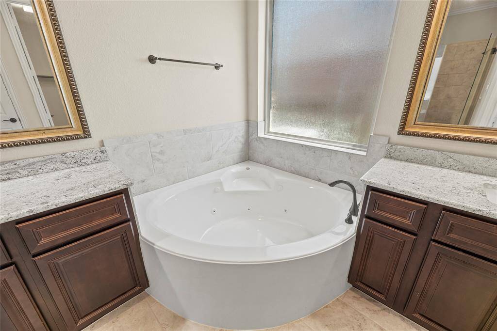 The deep soaking jacuzzi tub offers a serene retreat, inviting you to unwind and indulge in relaxation.