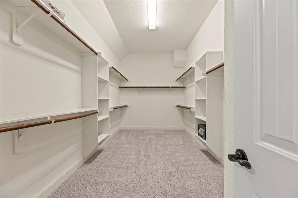 Look at this primary closet! Generous space is an understatement.  Your entire wardrobe will fit while keeping everything neatly organized and easily accessible.
