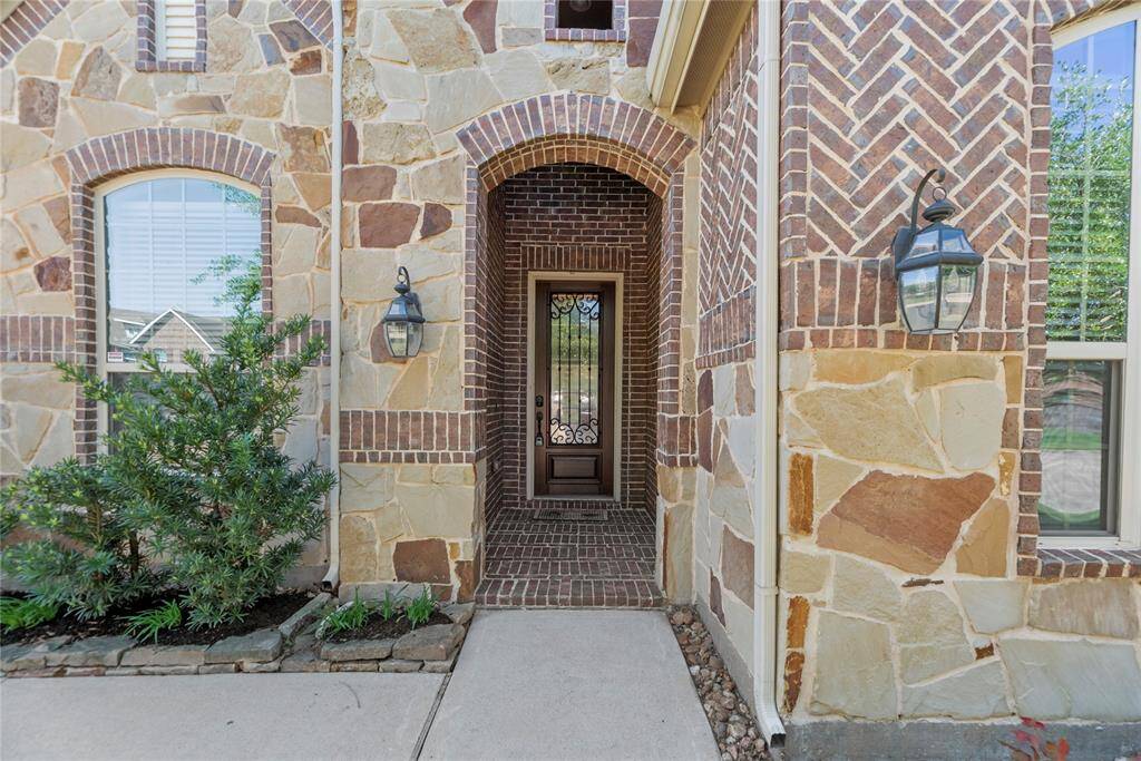 The beautiful stone and brick exterior exudes charm and elegance, creating exceptional street appeal that captivates at first glance.