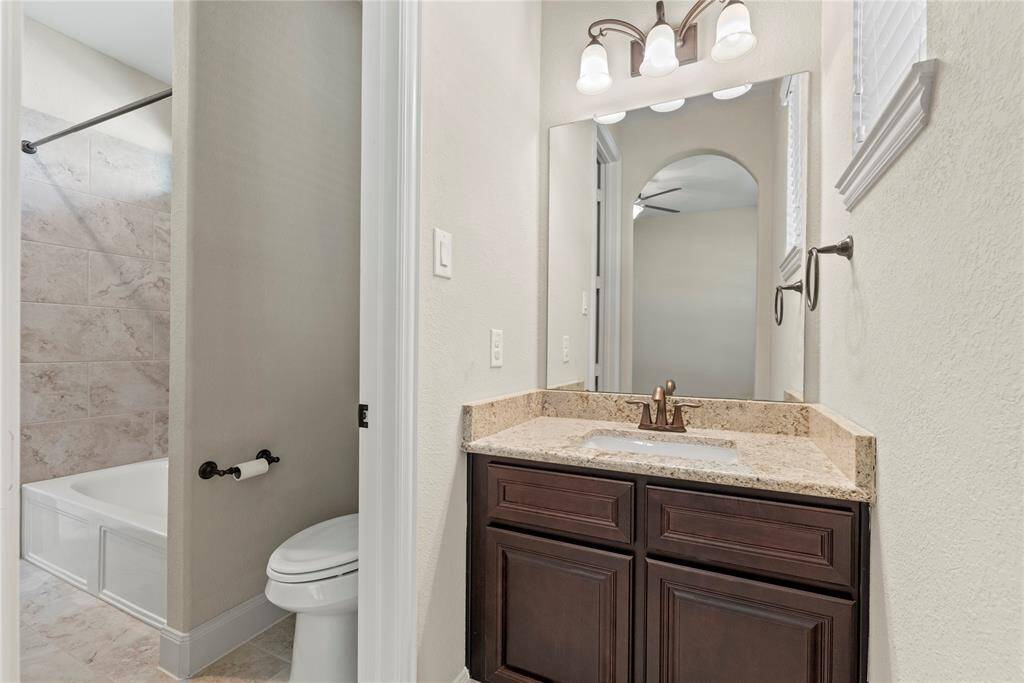The private en-suite bath features a spacious vanity, making busy mornings a breeze for the whole family.
