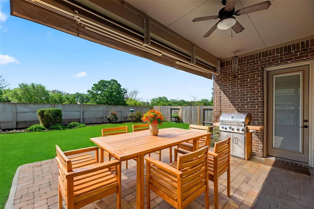The extended covered patio with manual awning, is an easy place to sit back and watch the sunset or just get some "you time" in the fresh air. - virtually staged