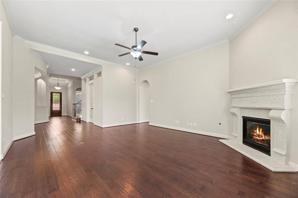 The living room, adjacent to the kitchen and breakfast area, offers a comfortable and inviting space for relaxation and socializing.