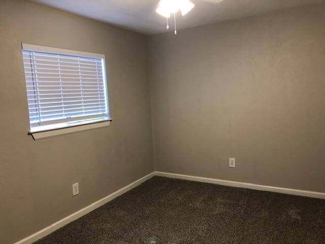 Large secondary bedroom with ceiling fan, new carpet and mini-blinds