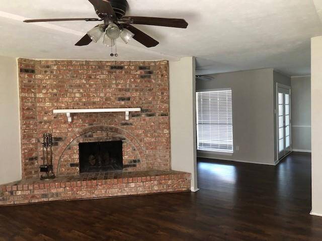 Large corner woodburning fireplace and new plank flooring
