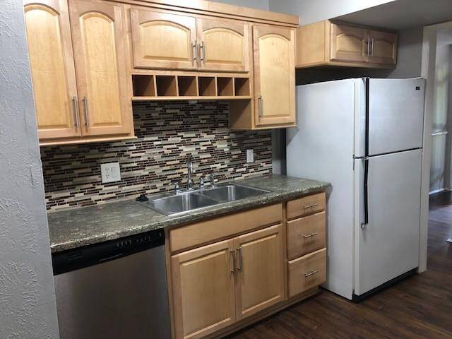 Updated kitchen with custom cabinets and plank flooring