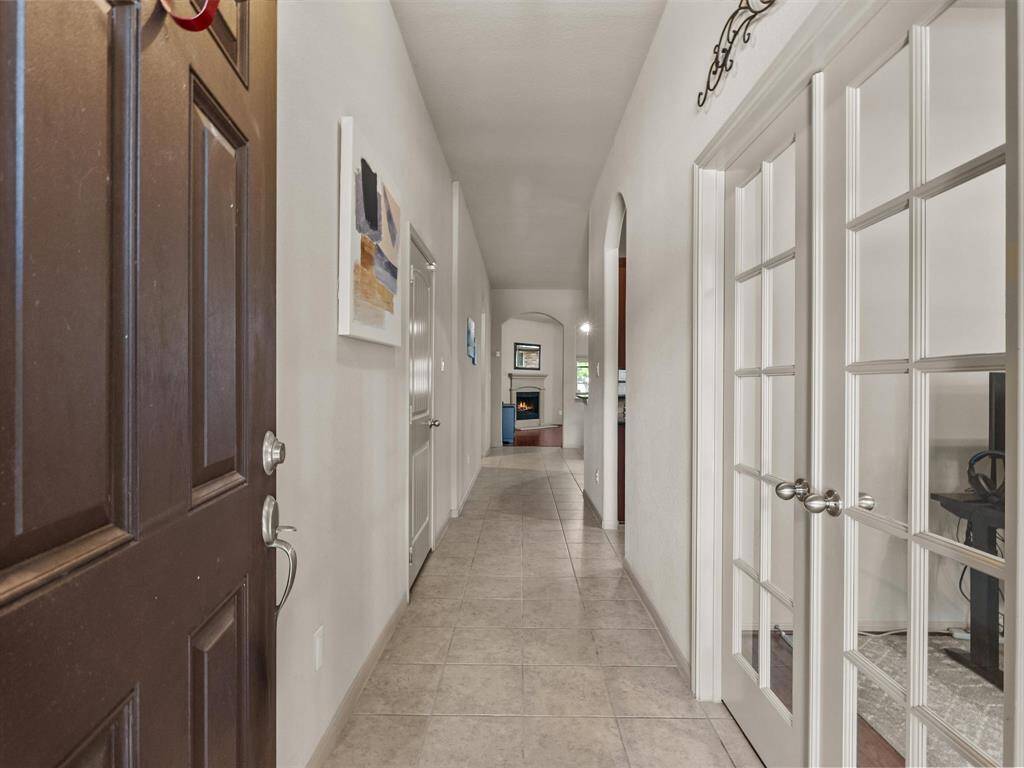Enter into this home with a view of the home office with French doors and the family room.