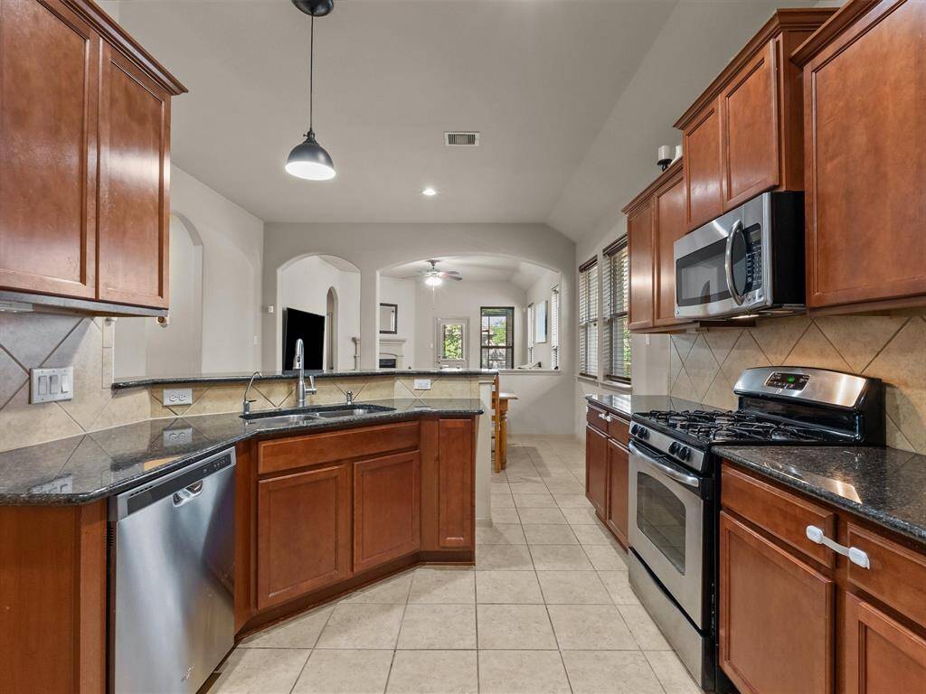 The kitchen overlooks the dining area and family room beyond.