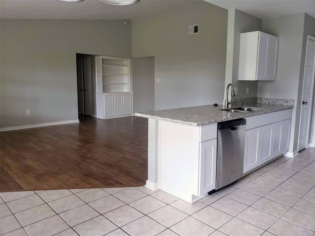 The empty living/kitchen area and cute built-ins just as you enter the home.
