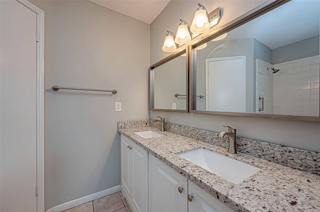 Primary bath offers double sinks and a newly remodeled bath/shower.