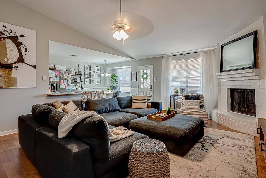 The living is open to the kitchen/dining in area. Vinyl plank flooring throughout the living room and bedrooms makes the space seem even larger than it is! The cozy fireplace showcases the cozy living space while having a large picture window into the huge backyard.
