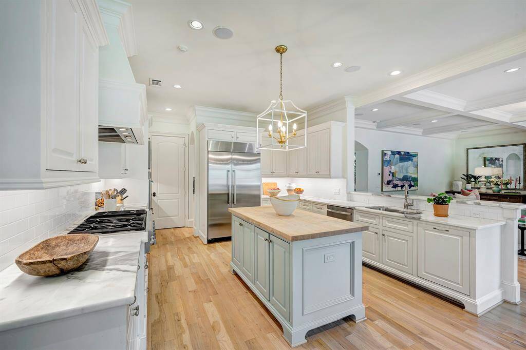 The kitchen features a large island and an abundance of countertop space for culinary creativity.