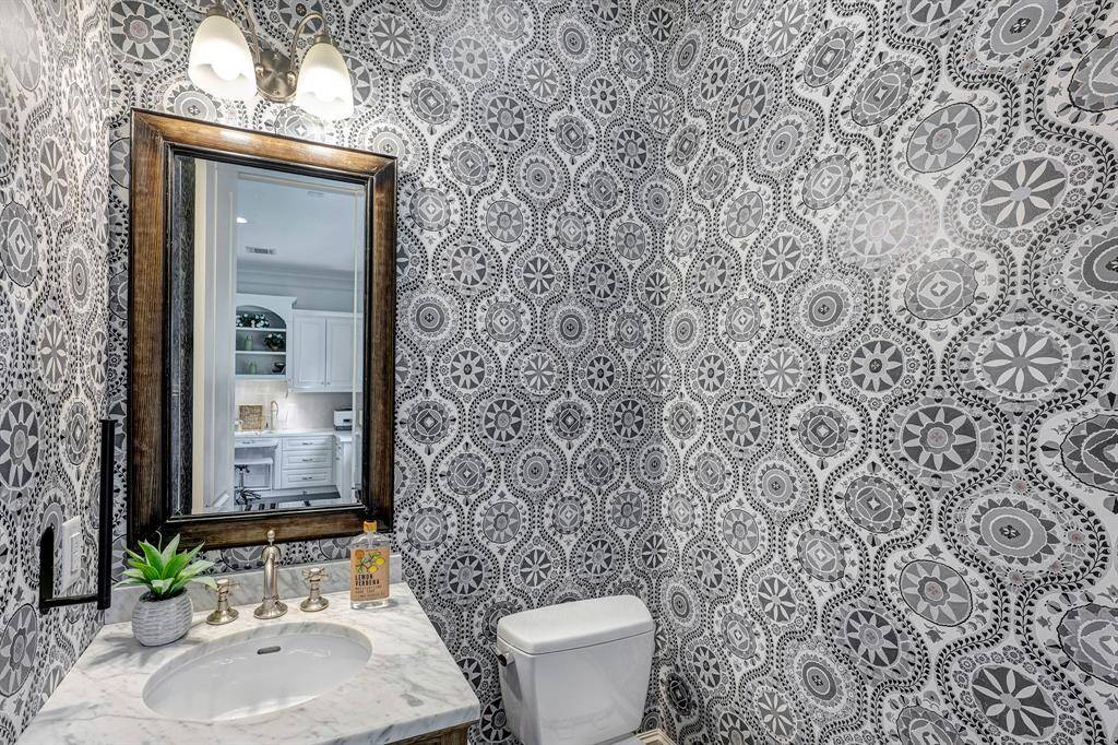 Another half bath is located just beyond the home office/study.