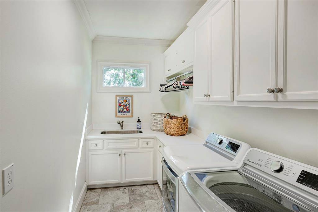 Laundry room with sink, folding counter, and storage.