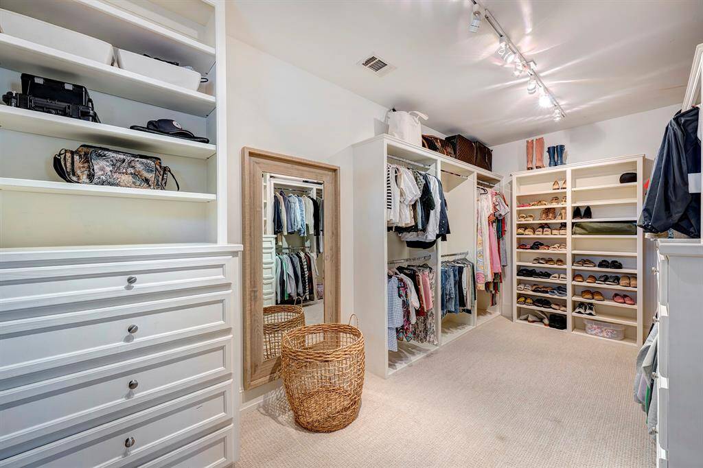 Expansive primary closet with built-ins.