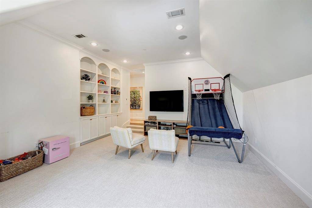 The game room is a versatile space, complete with built-ins for added functionality.