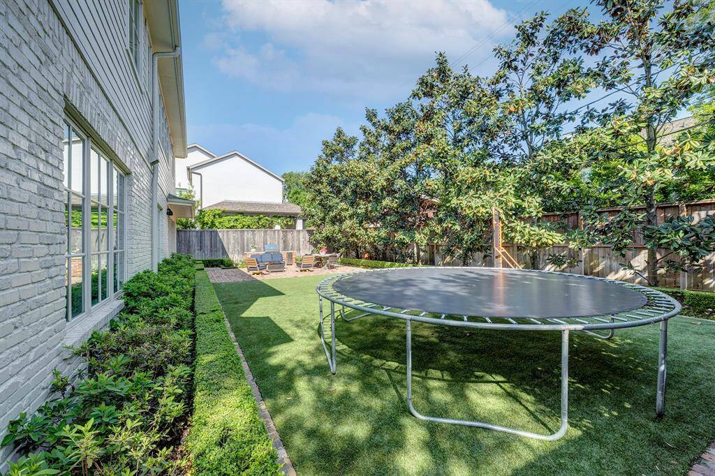 The backyard is fully fenced and is great for play, relaxation, and pets.