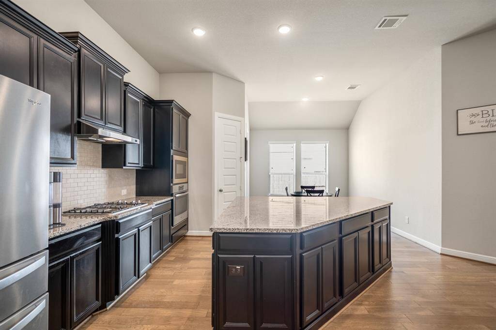 This stunning kitchen is perfect for everyday life as well as entertaining family and friends! conveniently connects to the breakfast area and living room.