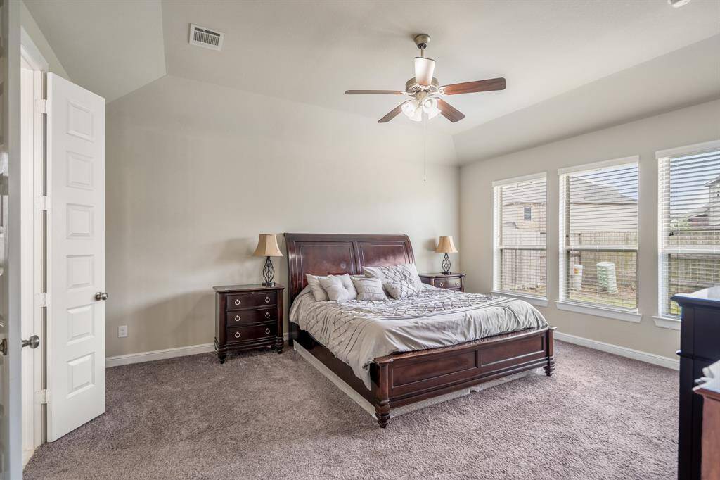 The primary bedroom welcomes you with bright natural light, high ceilings, plush carpet, and the perfect view of the serene yard. It sits at the back of the home offering additional privacy and easily fits a king size bed plus furniture!