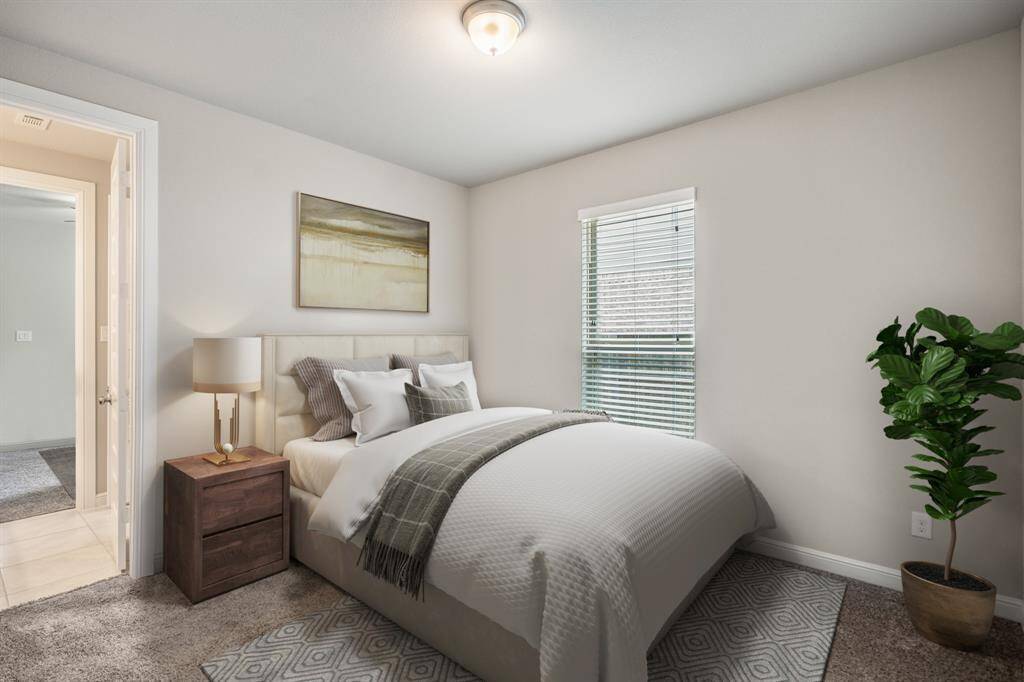 The spacious secondary bedroom includes plush carpet, neutral paint, and directly connects to the spacious 3rd shared bathroom! *This room has been virtually staged.