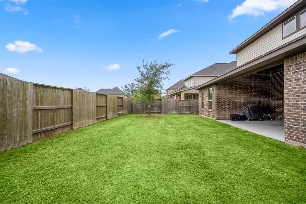 Your covered patio overlooks your huge backyard with plenty of green space to enjoy!
