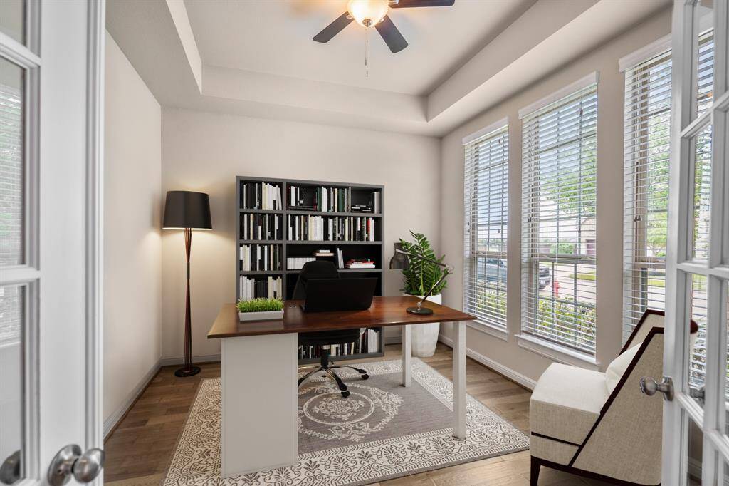 Tucked away at the front of the home is the home office! Accented by elegant tray ceilings, a modern ceiling fan, and timeless architectural touches, this room also features timeless French doors, large windows and bright natural light! *This room has been virtually staged