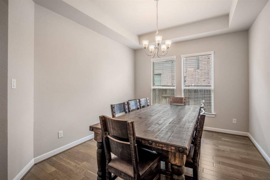 Make memories gathered around the table with your family and friends! This dining room features high ceilings, hardwood floors, large windows, and a beautiful chandelier!