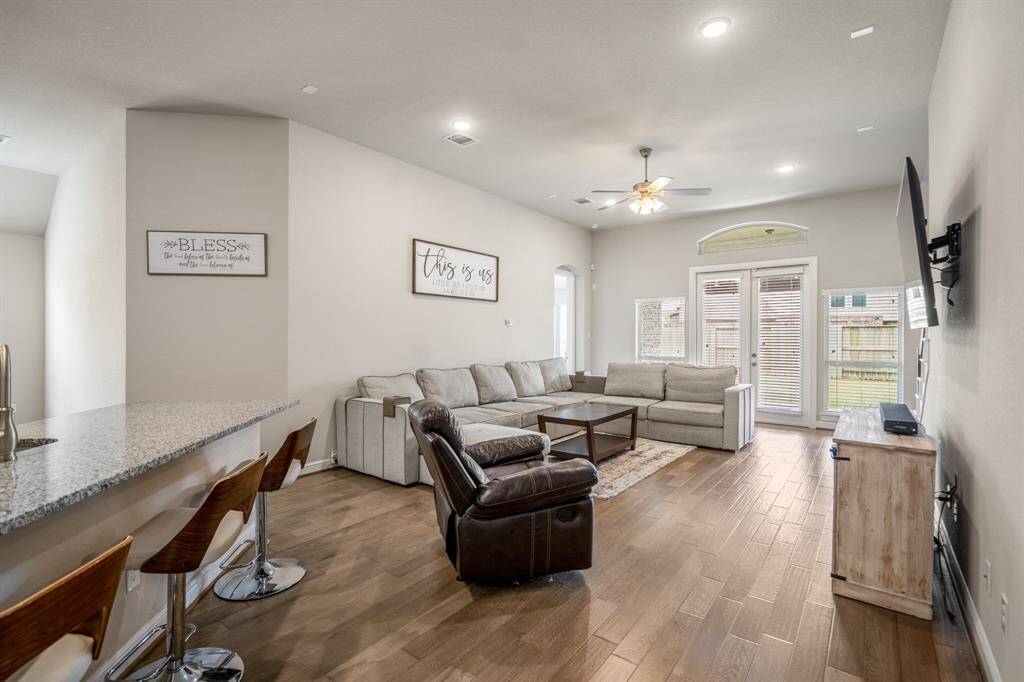 Gather the family and guests together in your huge living room! Featuring high ceilings, dark stained ceiling fan, gorgeous wood floors, and large windows that provide plenty of natural lighting throughout the day!