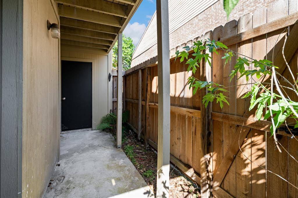 Charming fenced patio offers privacy and low-maintenance outdoor space with direct access from the living area.