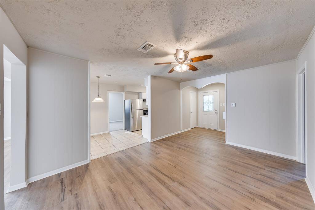 The inviting entryway opens up to a beautifully integrated space, seamlessly connecting to the dining room and kitchen. This open layout enhances the sense of spaciousness, while abundant natural light flows throughout, creating a warm and welcoming atmosphere ideal for both daily life and entertaining.
