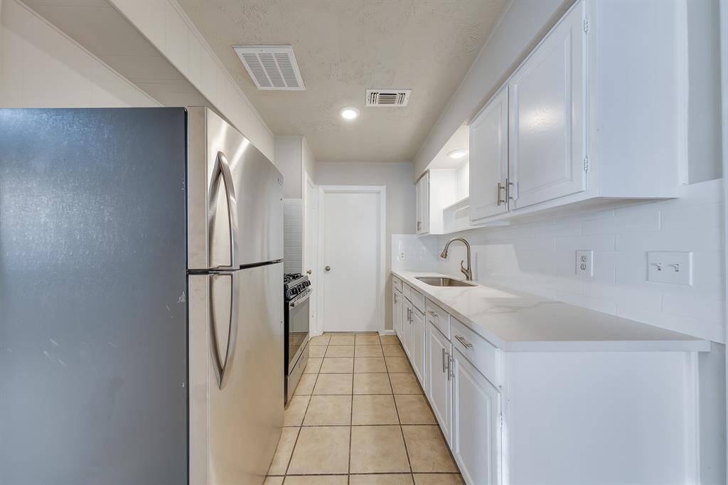 This well-appointed kitchen offers a nice sense of privacy, positioned away from the living area to minimize distractions while cooking. With ample counter space and modern amenities, it provides an ideal environment for culinary creativity, making it both functional and inviting for those who love to cook.
