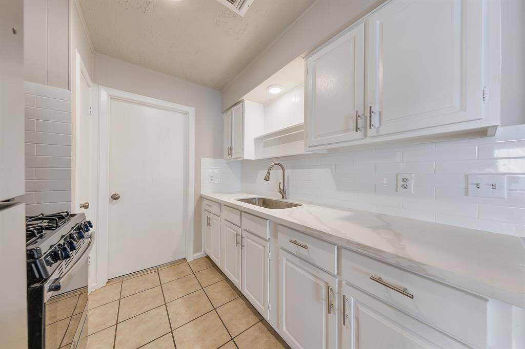This kitchen boasts generous counter and cabinet space, providing ample room for meal preparation and storage. The expansive countertops offer plenty of workspace for cooking and entertaining, while the abundant cabinetry ensures that everything is easily organized and within reach, making this kitchen as practical as it is stylish.