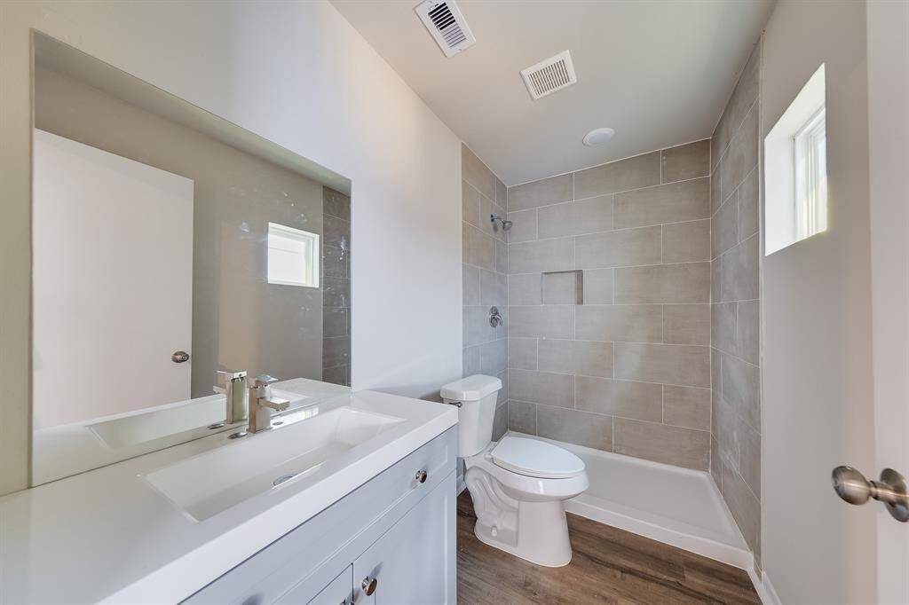 The primary bathroom offers a private oasis, designed for both comfort and style. With its updated features, including elegant shower tiles and a spacious shower area, it provides a luxurious retreat. The thoughtful layout ensures privacy while enhancing the overall sense of tranquility, making it the perfect spot to unwind after a long day.