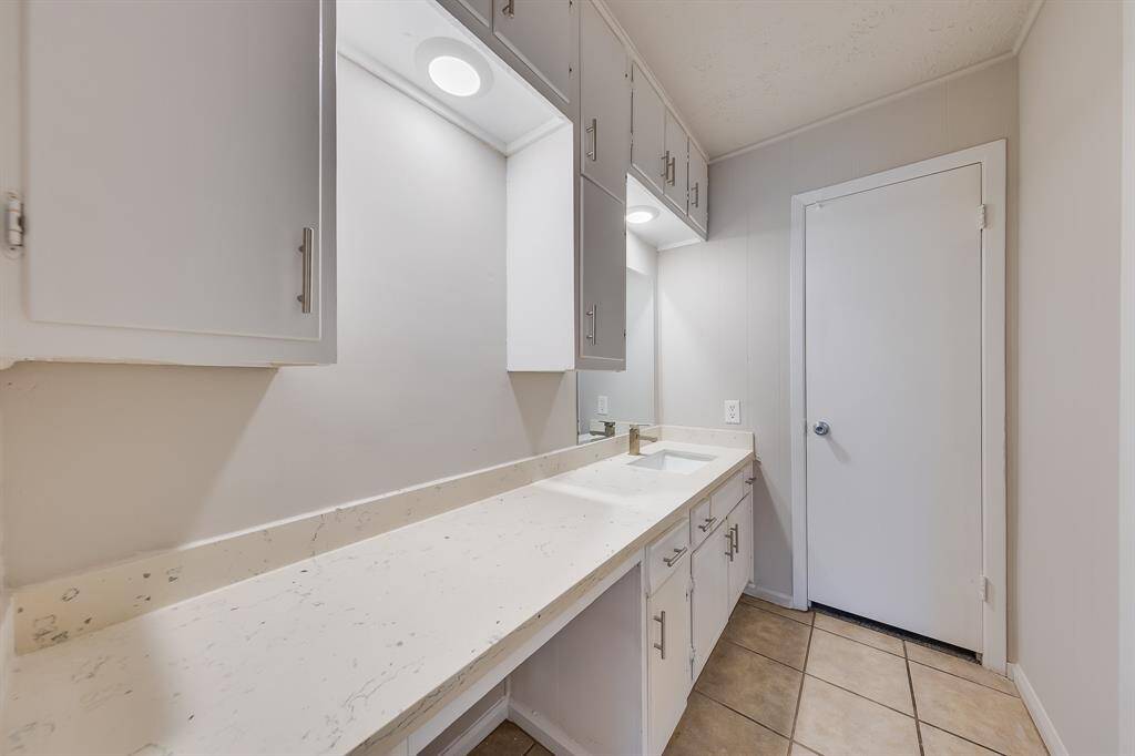 The second bathroom features generous counter space, providing ample room for your essentials and personal items. This thoughtful design enhances functionality while offering a stylish setting, making it a practical yet inviting space for everyday use.