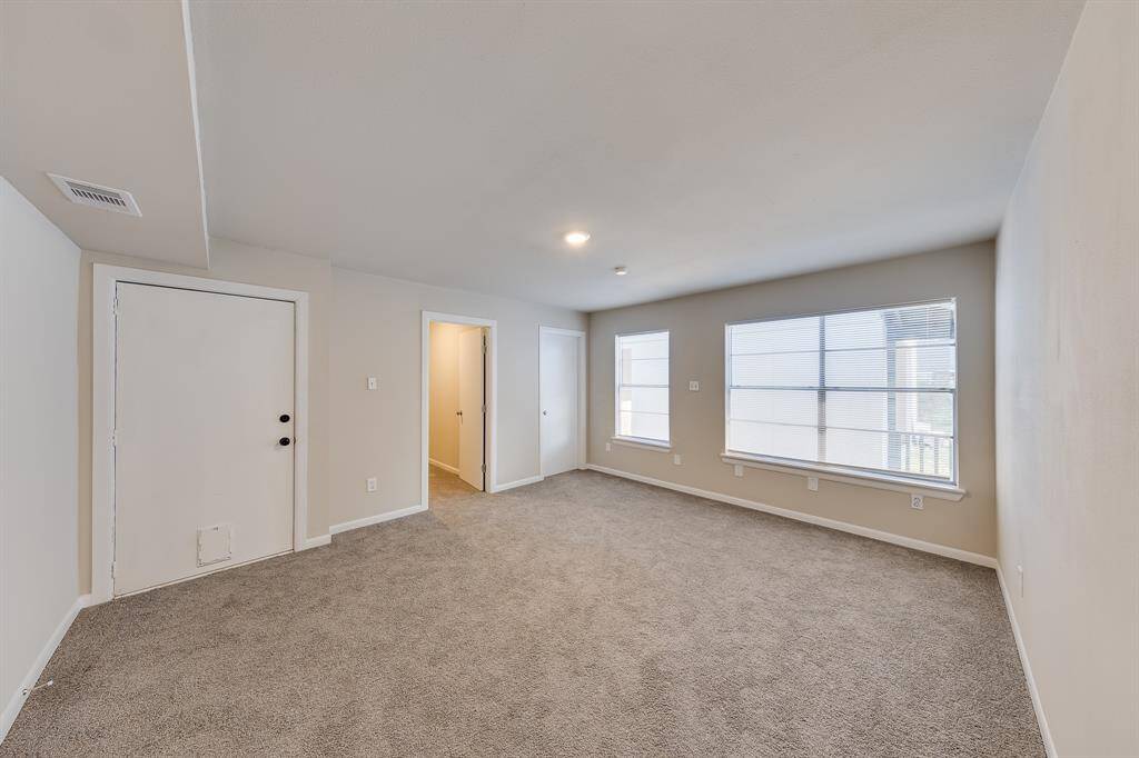 This spacious primary bedroom is bathed in natural light, thanks to large windows that create a bright and airy atmosphere. With ample room to relax and unwind, it offers the perfect retreat at the end of the day.