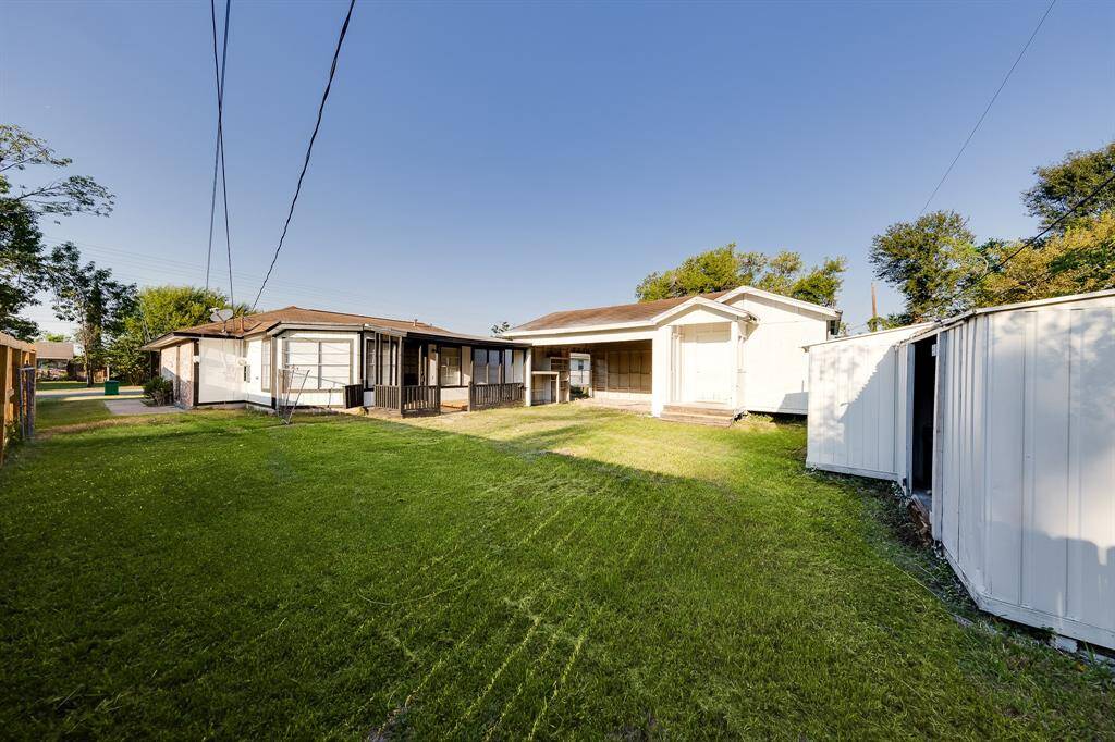 The backyard offers a fantastic outdoor retreat, showcasing a covered patio perfect for relaxing or entertaining. With a two-car garage, a convenient storage shed, and plenty of additional yard space, this area is both functional and inviting for all your outdoor activities.