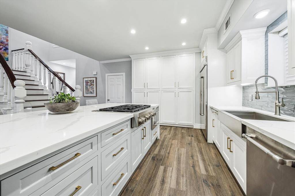 The kitchen features custom, onsite cabinetry that was thoughtfully designed to complement the finishes.
