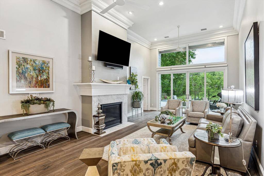 Experience cozy elegance in the living room, featuring a stunning floor-to-ceiling fireplace.
