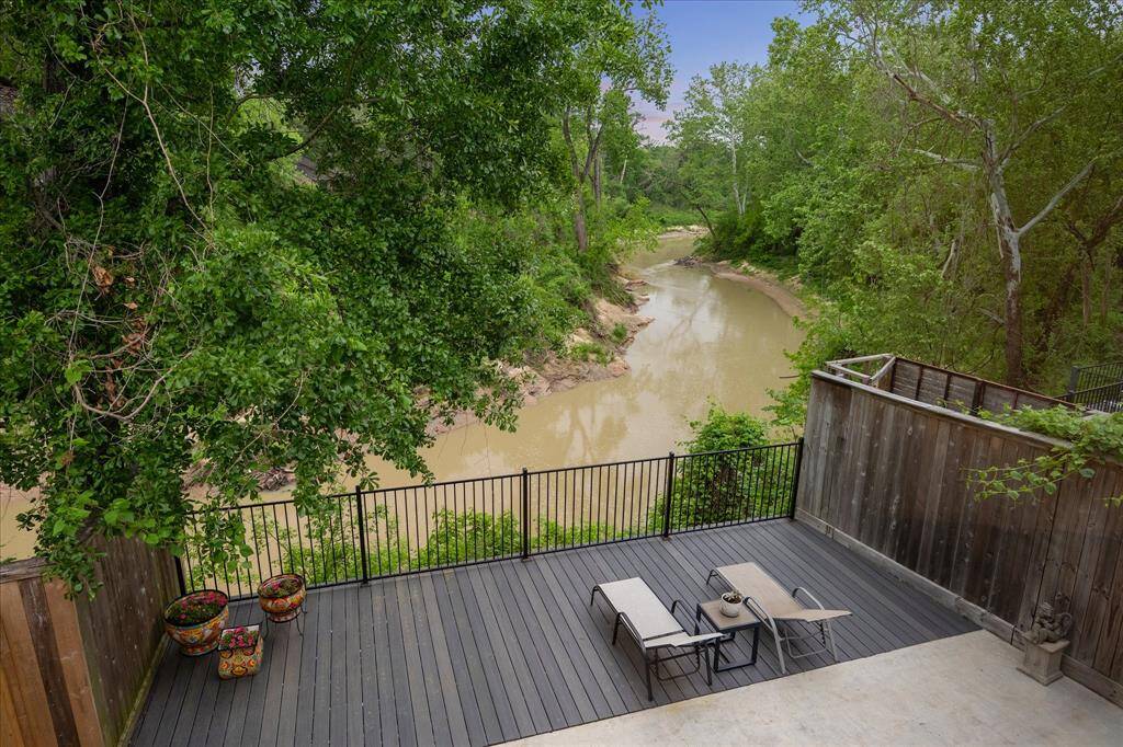 From the back deck, enjoy serene views of Buffalo Bayou and towering trees—a rare natural setting in the heart of Houston.
