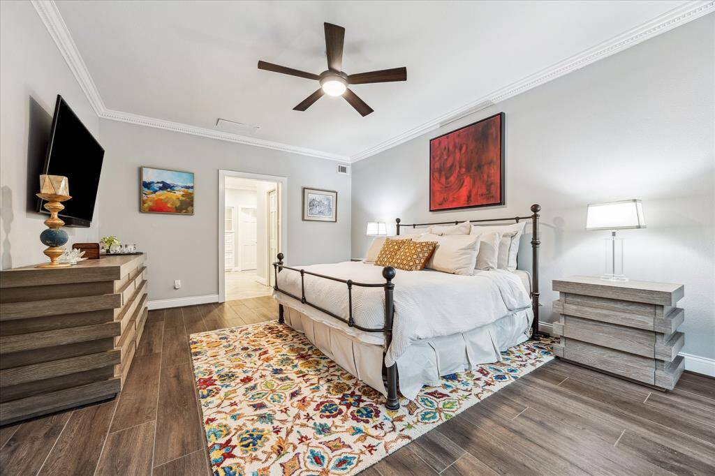 The primary bedroom, located on the first level, offers a serene retreat with an en-suite bath designed for ultimate relaxation.