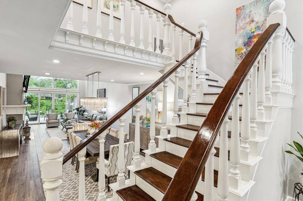 The elegant wood stairs lead to the second floor, featuring rich wood details that complement the home’s sophisticated design.