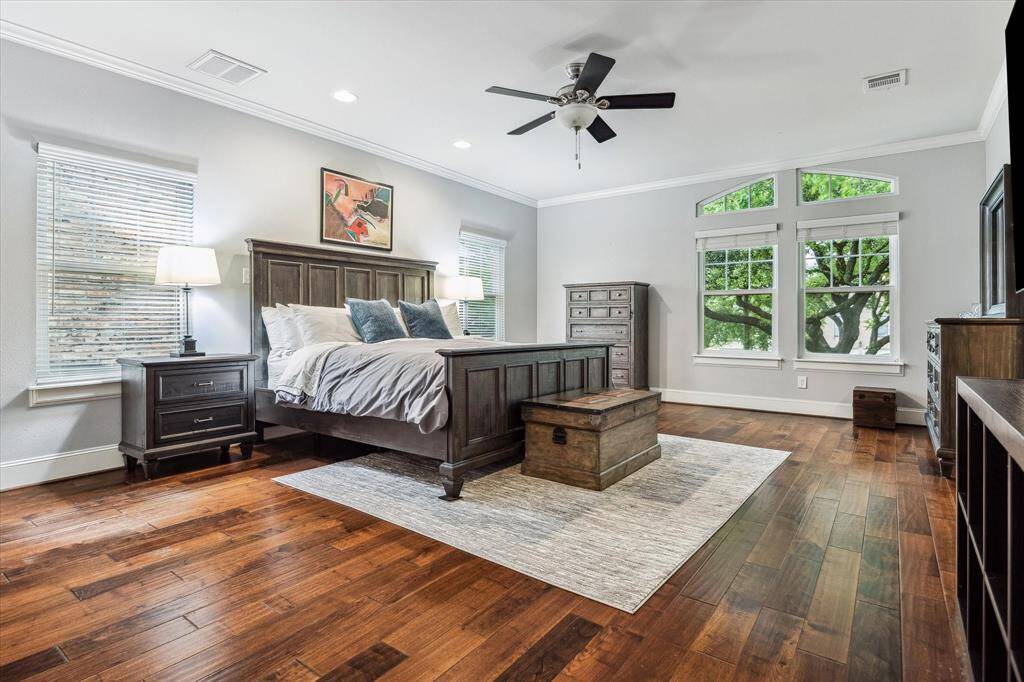 This large ensuite bedroom can be a second primary bedroom. It has a large walk-in closet and features a private bathroom. It has 10' ceilings as all of the second floor, rich wood floors and a view of the tree at the front of the home.