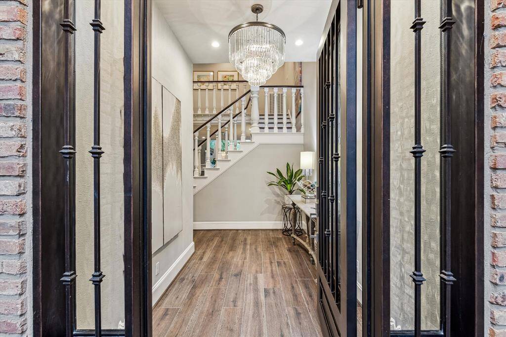 Enter this beautiful townhome through a striking glass-paneled door that leads into an inviting foyer. The space is highlighted by a stunning statement chandelier.