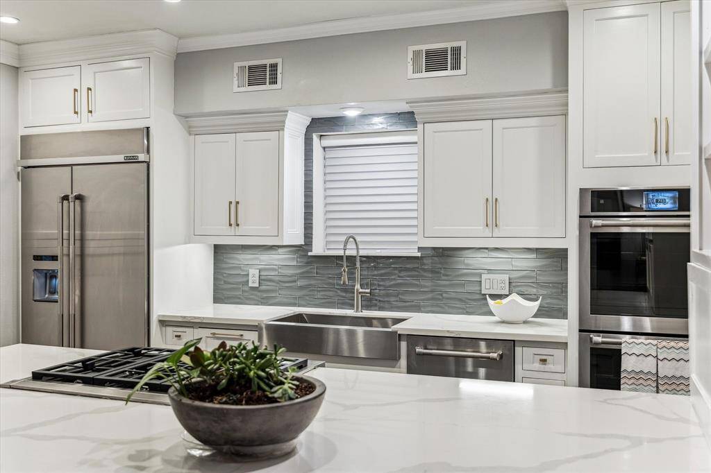 As part of the extensive $450K renovation, this gourmet kitchen was remodeled to perfection, featuring top-of-the-line finishes and state-of-the-art appliances.