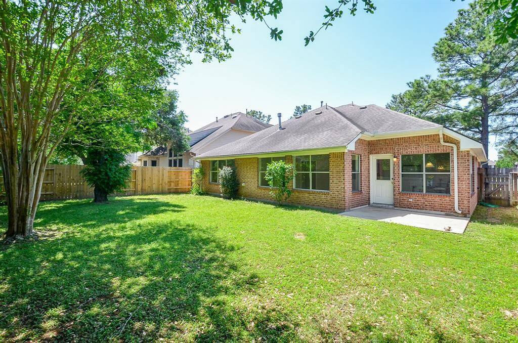 This home offers tons of outdoor space with a spacious, fenced backyard perfect for outdoor activities. Features a patio and mature trees providing shade and privacy.