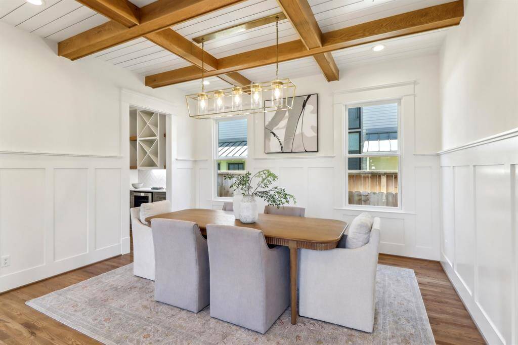 The dining space is handsomely appointed with panel molding and white oak Craftsman beams.