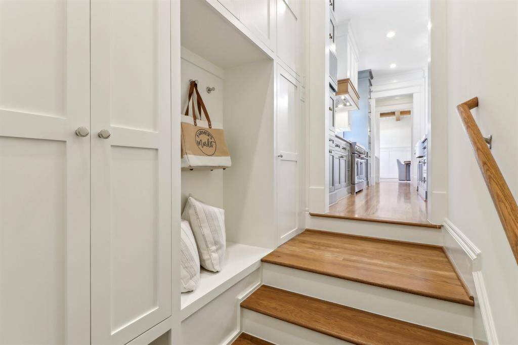 The mud room, just off the kitchen, leads to the garage & features jacket hooks, a shoe space beneath and closed storage.