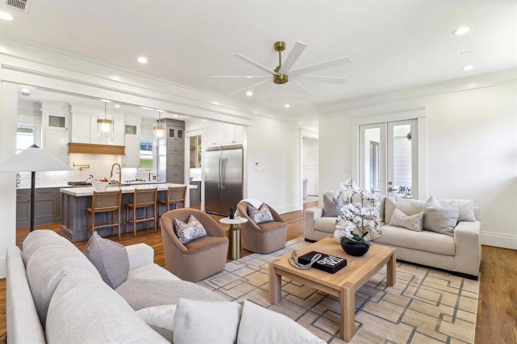 French doors lead off of the main living area to the sizable sitting porch, which leads to the yard.