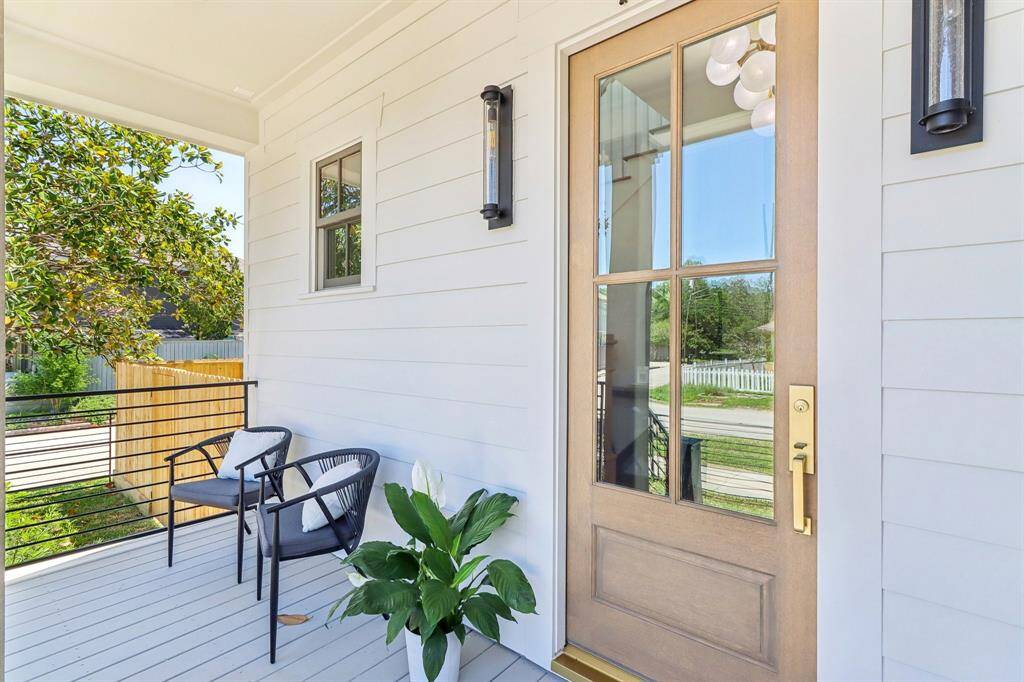 A gorgeous 4/4 front door is the defining feature of this comfortable front porch, a nice place to enjoy the north-facing shade and get to know your neighbors.